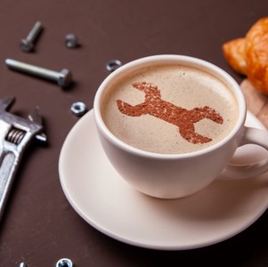 Tasse à café avec image de clef à molette dans la mousse de café